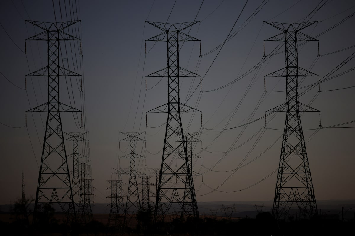 Pylons of high-tension electricity power lines are seen during sunset in Brasilia